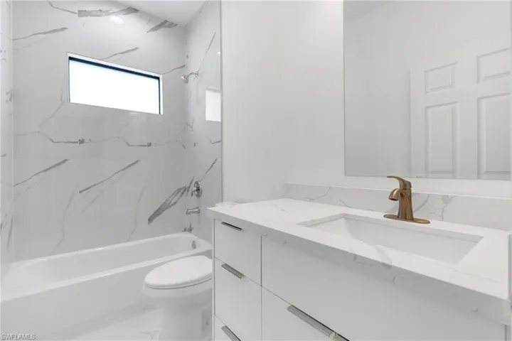 Bathroom featuring vanity and  shower combination