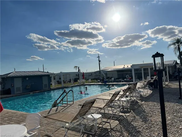 Community pool featuring a patio