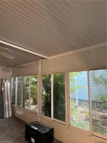 Sunroom / solarium featuring wood ceiling and wood finished floors