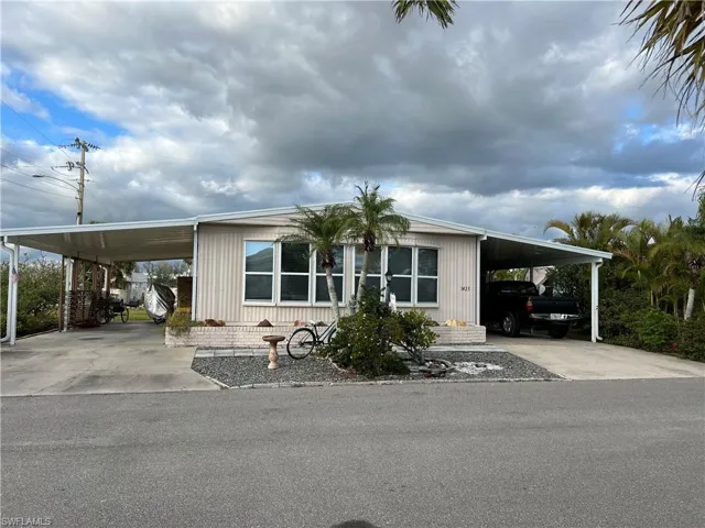 Manufactured home featuring corner lot, 2 carports to park 3 or more vehicles under carports