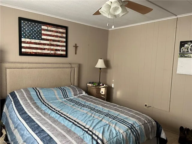 Bedroom featuring crown molding and ceiling fan