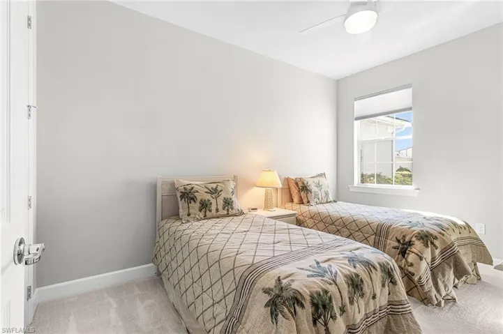 Bedroom featuring light carpet and ceiling fan