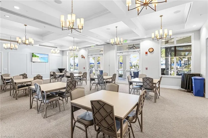 Dining area with light colored carpet, crown molding, coffered ceiling, healthy amount of natural light, and recessed lighting
