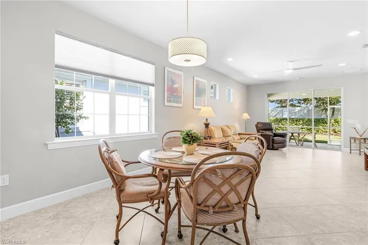 Dining space with a ceiling fan, recessed lighting, and light tile patterned floors