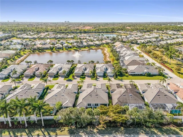 Aerial perspective of suburban area featuring a nearby body of water