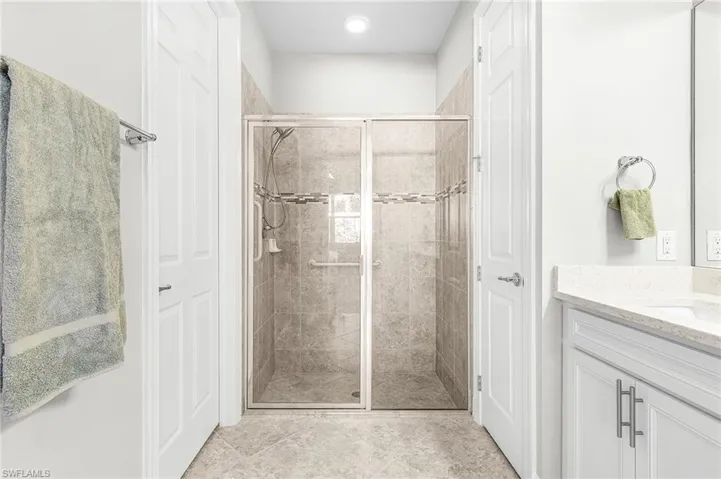 Bathroom featuring a stall shower and vanity