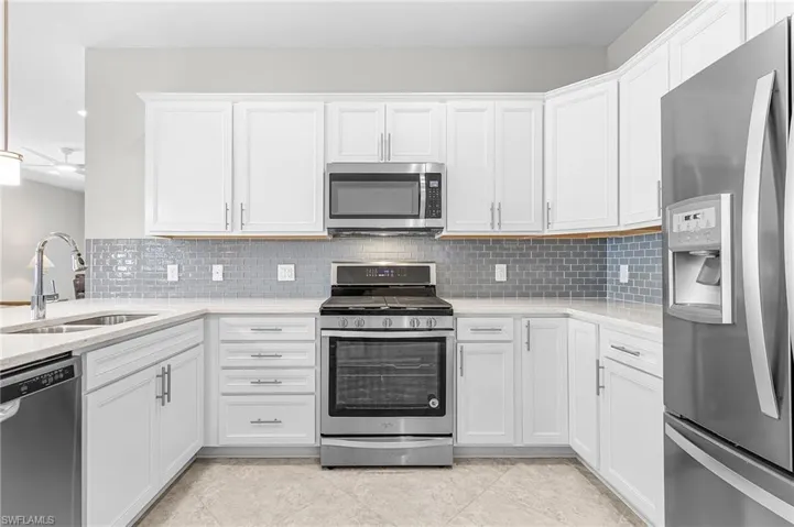 Kitchen with stainless steel appliances and white cabinets