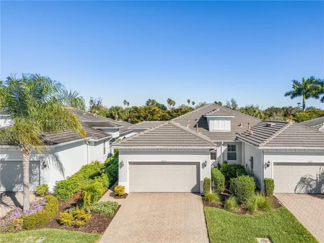 Single story home featuring stucco siding, decorative driveway, an attached garage, and a tile roof