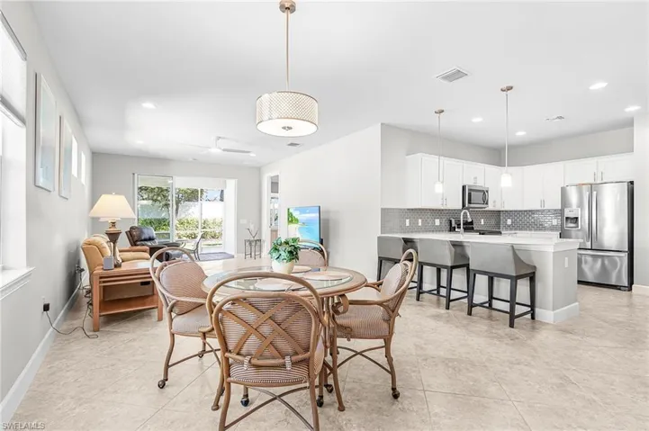 Dining room featuring recessed lighting, ceiling fan, and light tile patterned floors