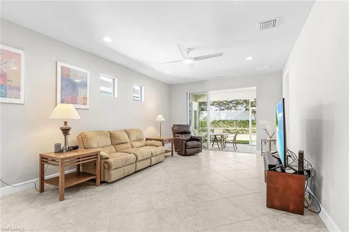 Living area featuring plenty of natural light, a ceiling fan, recessed lighting, and light tile patterned flooring