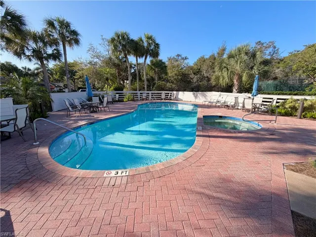 Community pool with a community hot tub and a patio area