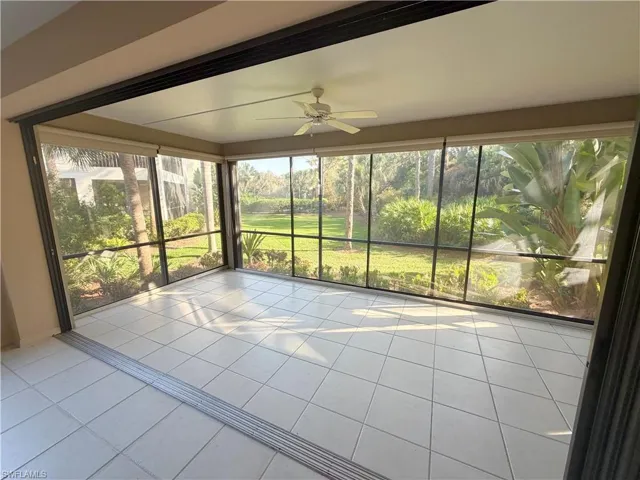 Unfurnished sunroom featuring tile patterned floors