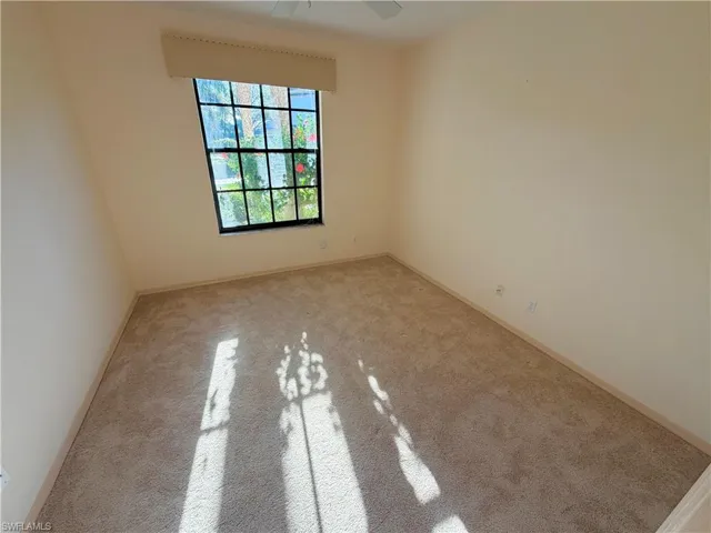 Unfurnished room with light carpet and a ceiling fan