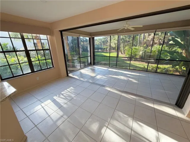 Empty room featuring a ceiling fan and light tile patterned floors