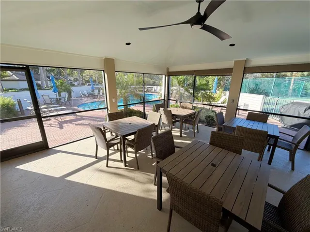 Sunroom featuring plenty of natural light and lofted ceiling