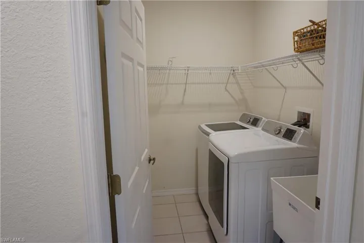 Laundry room with utility sink and washer and dryer