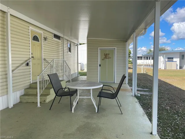 View of patio featuring outdoor dining area and entry steps