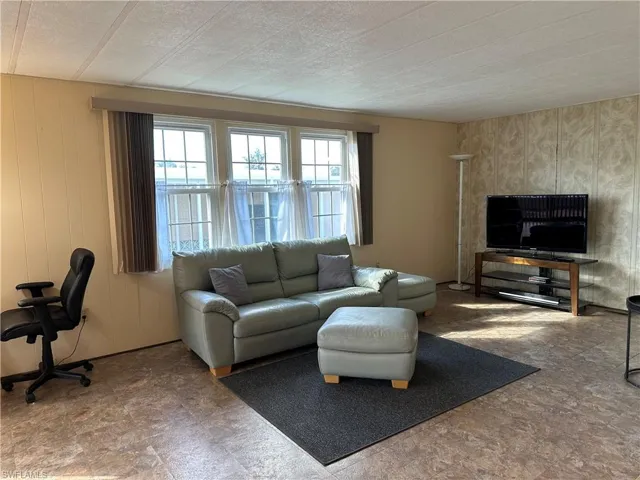 Living area featuring wooden walls