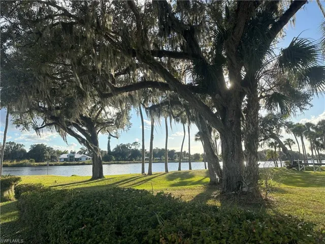 View of grassy yard with a water view