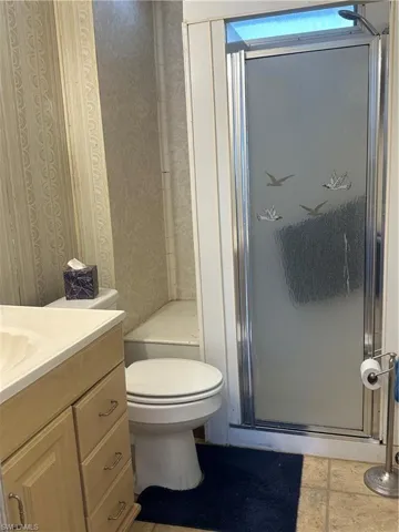 Bathroom with vanity and a stall shower