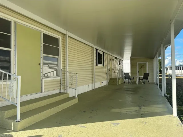 View of patio featuring entry steps and an attached carport