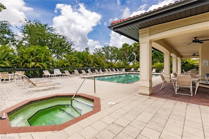 View of swimming pool with a patio, ceiling fan, and a community hot tub