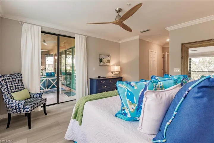 Bedroom featuring access to outside, light wood-type flooring, ceiling fan, and ornamental molding