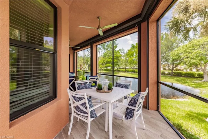 Sunroom / solarium with a water view and ceiling fan