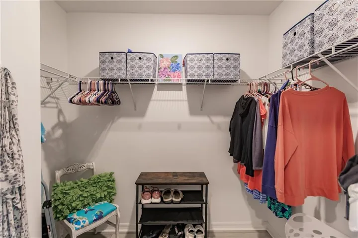 View of 1 of 2 master walk in closets