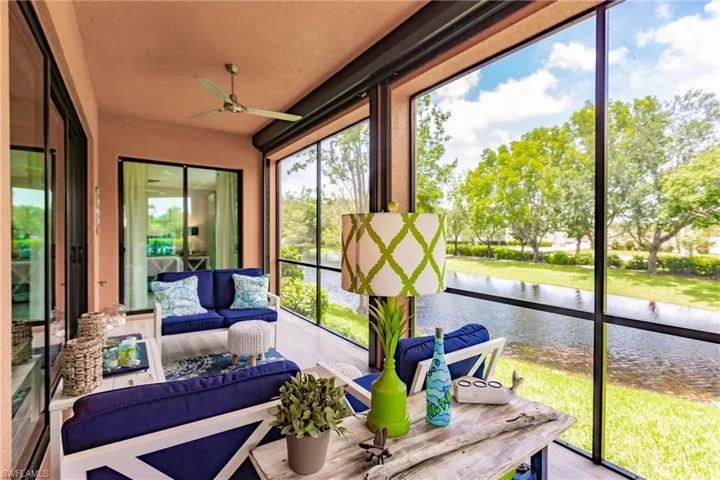 Sunroom with a water view and ceiling fan