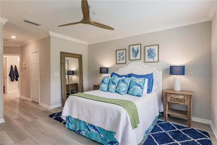 Bedroom with ornamental molding, a closet, ceiling fan, and hardwood / wood-style floors