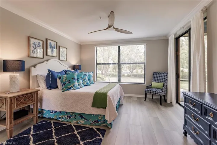 Bedroom featuring access to outside, wood-type flooring, ceiling fan, and crown molding