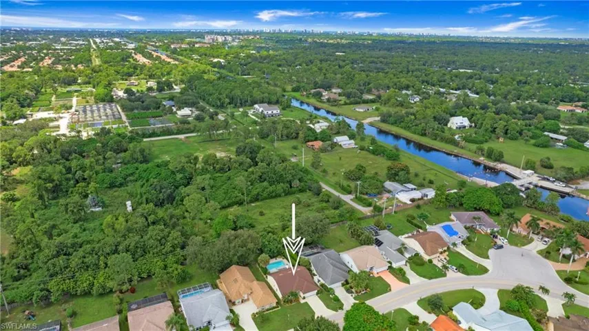 Aerial overview of property's location with nearby suburban area and a large body of water