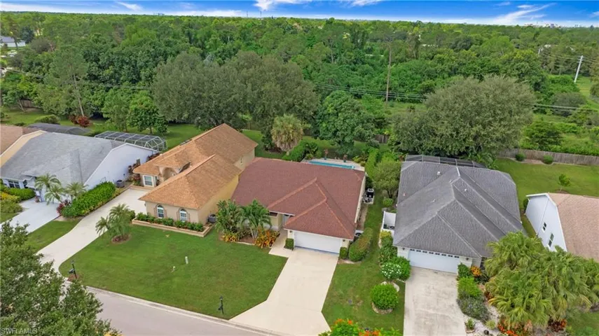 Aerial view of residential area with a heavily wooded area