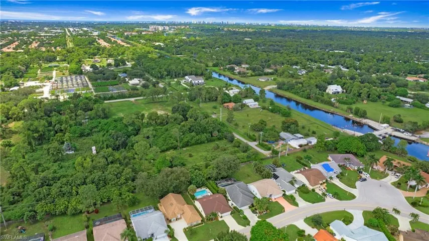 View of property location with nearby suburban area and a nearby body of water