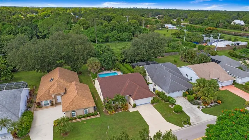 Aerial perspective of suburban area with a forest