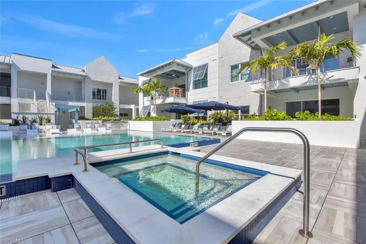 View of swimming pool with a patio area and a hot tub