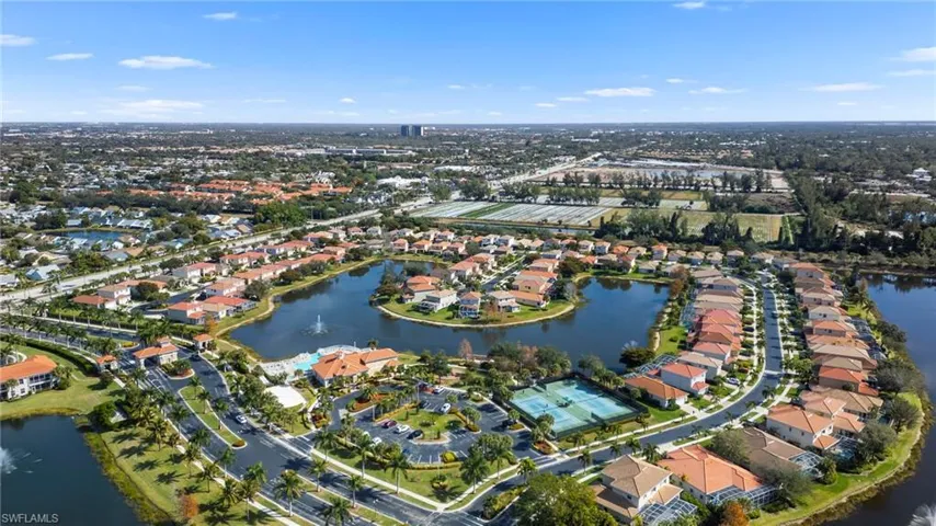 Aerial view of property's location with a large body of water and nearby suburban area