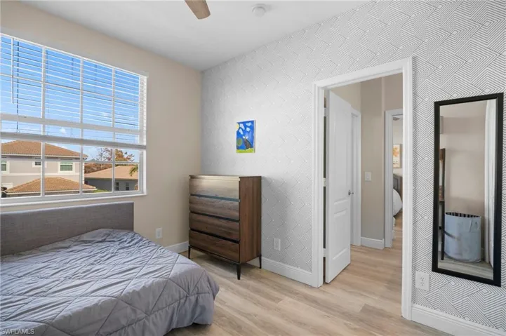 Bedroom with light wood-style floors and ceiling fan