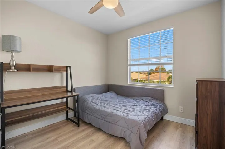 Bedroom with wood finished floors and a ceiling fan
