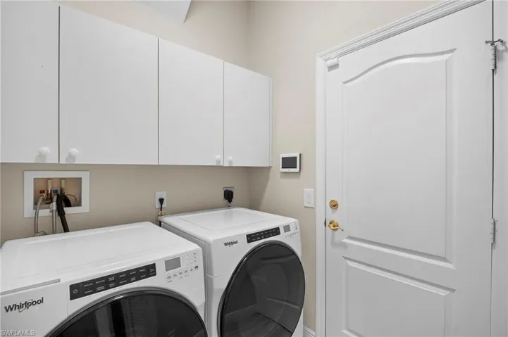 Laundry room featuring cabinet space and washer and dryer