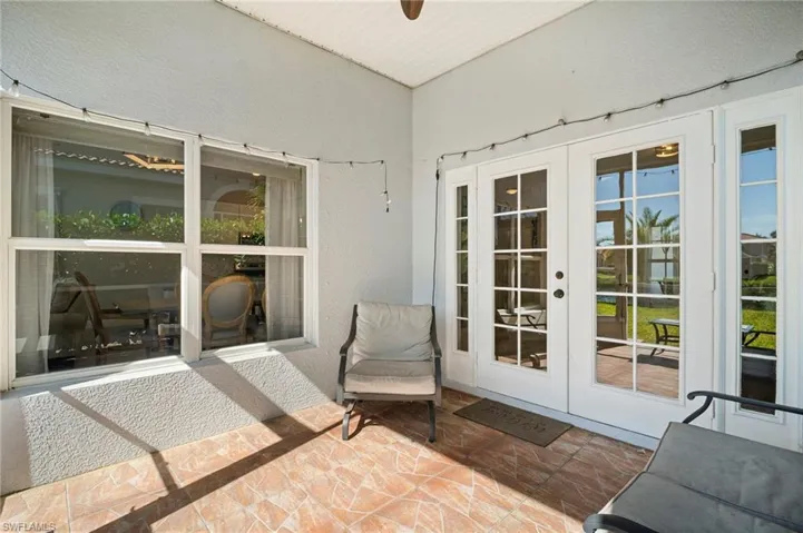 Sunroom / solarium with french doors and a patio