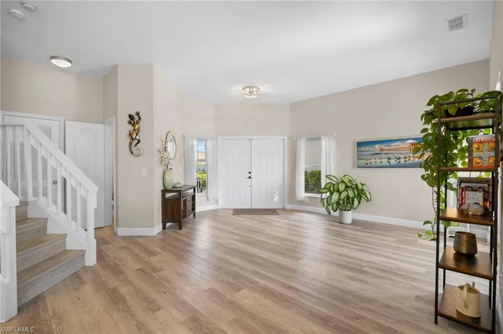 Foyer featuring light wood finished floors and stairs