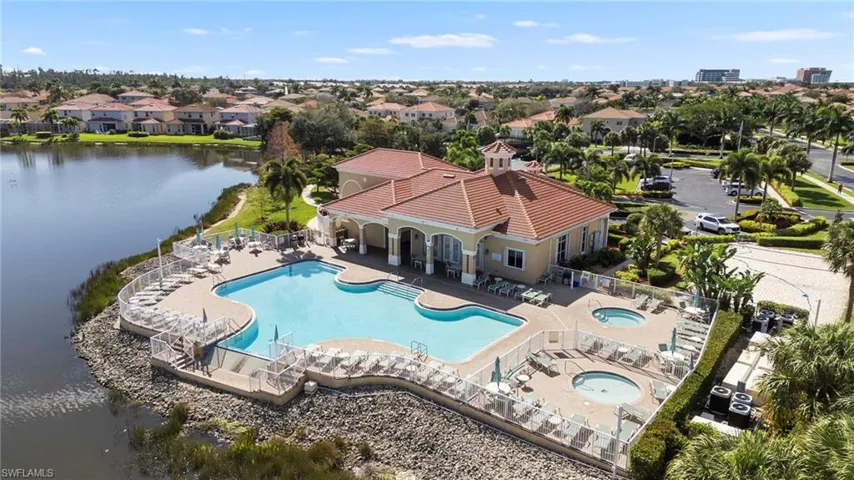 Aerial view of a pool and a large body of water