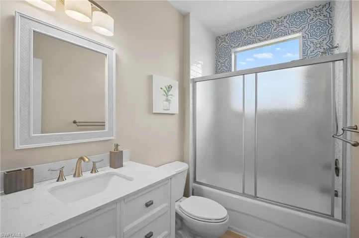 Full bathroom featuring enclosed tub / shower combo and vanity