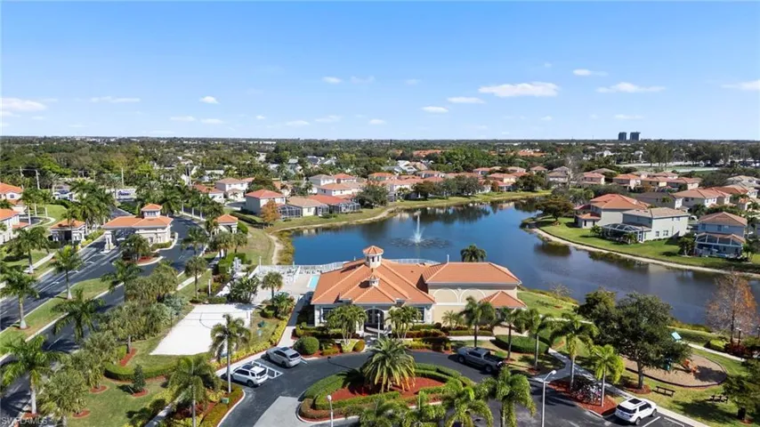 Aerial perspective of suburban area featuring a nearby body of water