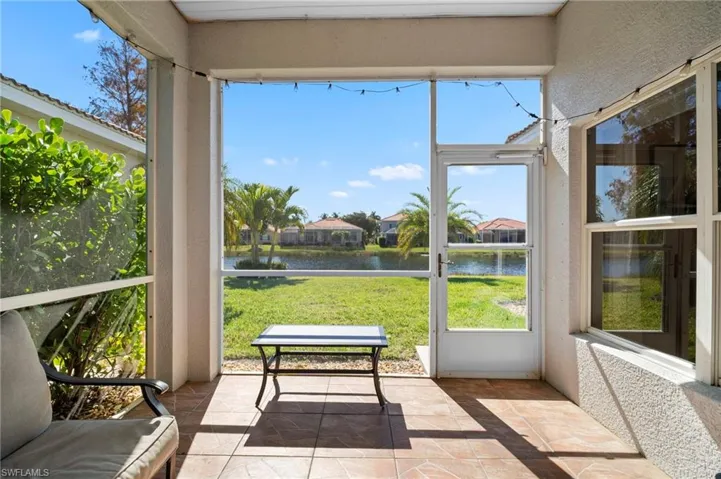Sunroom with a water view and a textured wall
