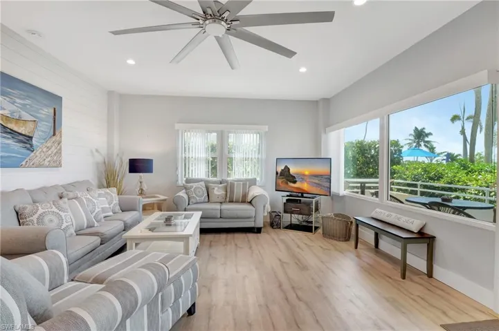 Living room featuring light hardwood / wood-style flooring and ceiling fan