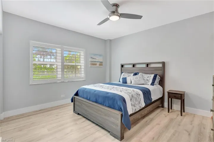 Bedroom with light hardwood / wood-style flooring and ceiling fan
