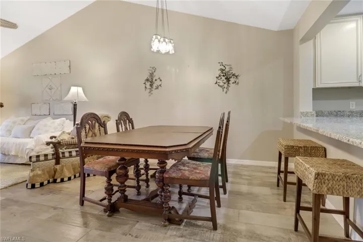 Dining area featuring an inviting chandelier and vaulted ceiling